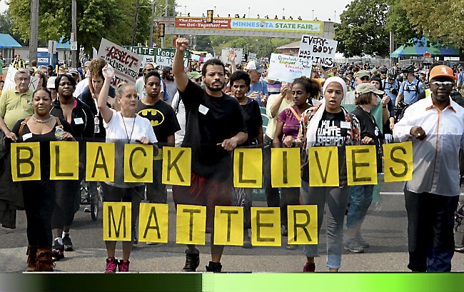 Black Lives Matters demonstrators marched east along Como Avenue towards the main gate of the Minnesota State Fair Grounds in Falcon Heights, on Saturday, August 29, 2015. (Pioneer Press: John Autey)