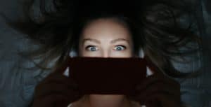 Woman staring at media on phone_Arsenii Palivoda/Shutterstock.com_spectator.org