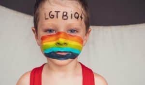 Child with LGBT flag face paint, illustrating piece on gender indoctrination in schools (23 estudio/Shutterstock.com) spectator.org