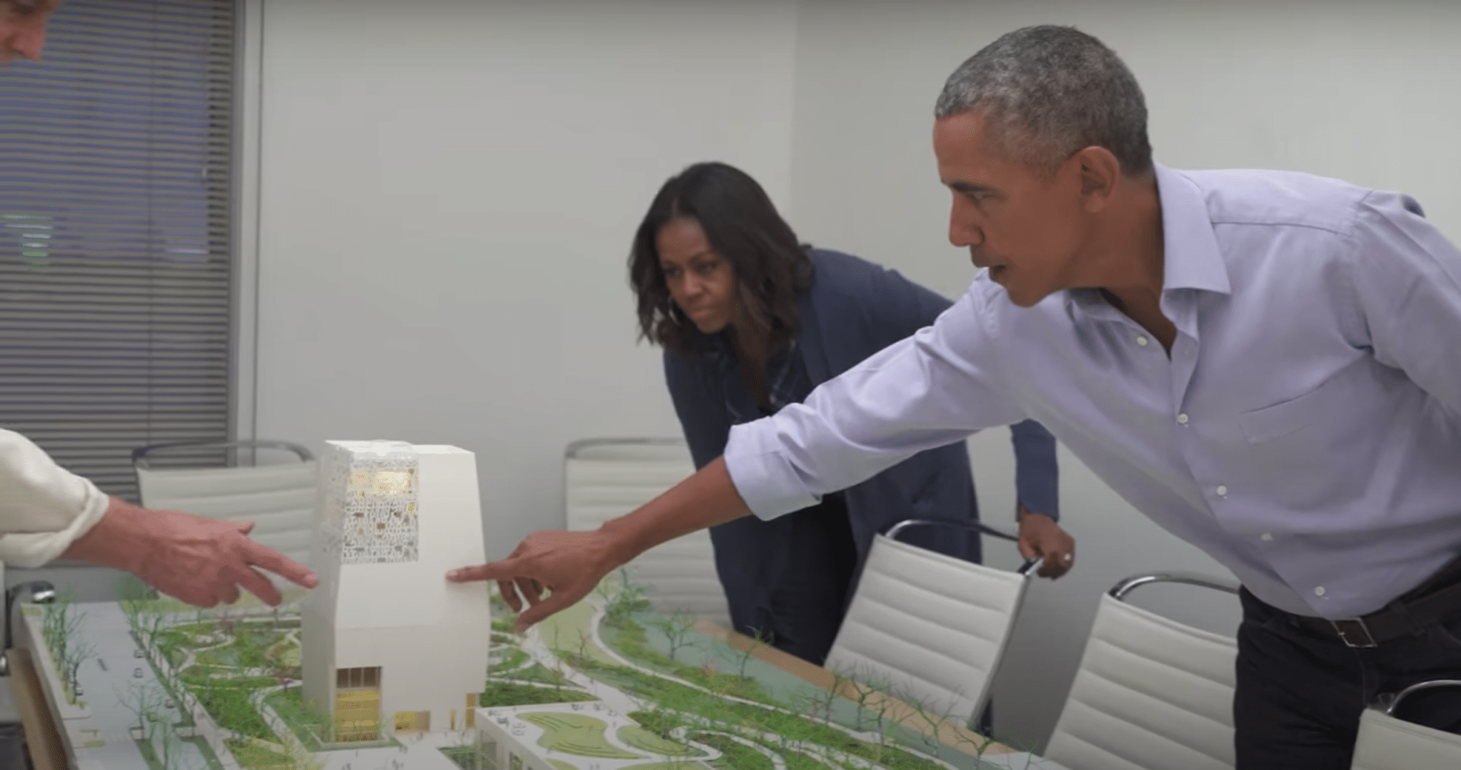 Obama examines the model of the campus of the Obama Presidential Library. (Obama Foundation/Youtube)