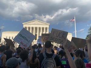 Pro-abortion demonstrators outside the Supreme Court chanting “F*** Joe Manchin,” “F*** Mitch McConnell,” and “Abortion is Human Right” (Hunter Oswald/ The American Spectator)
