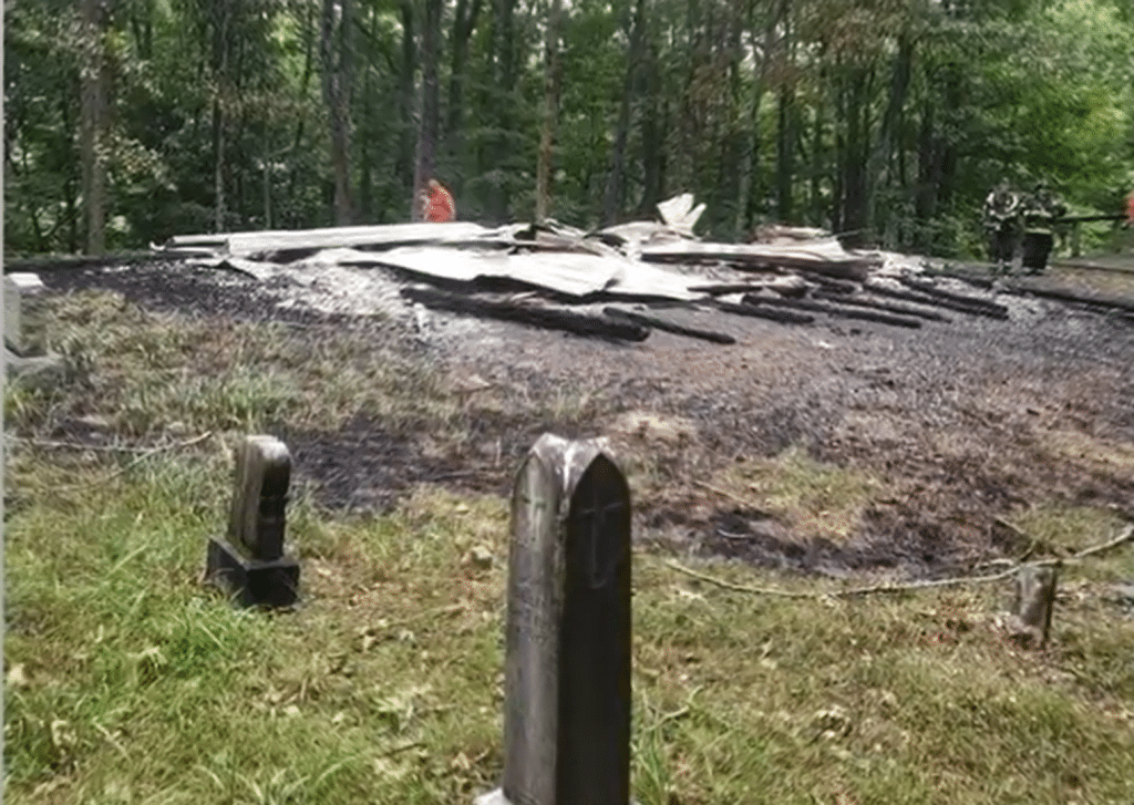 The charred remains of St. Colman Catholic Church after the fire on June 26, 2022.