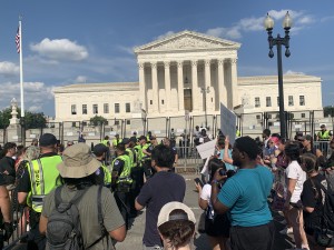 police and security putting themselves between pro-abortion and anti-abortion demonstrators after a physical altercation between members of the pro-abortion and anti-abortion sides (Hunter Oswald/ The American Spectator)