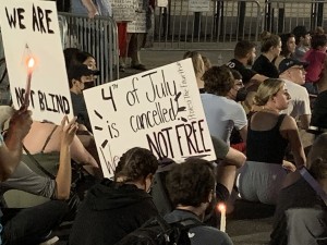 Pro-abortion protesters holding signs and candles during the solemn Sunday night’s candlelight vigil, mourning the repeal of Roe and Casey (Hunter Oswald/ The American Spectator)