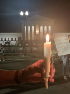 A pro-abortion activist holding a candlelight in Front of Supreme Court during Sunday night’s candlelight vigil, which the pro-abortion protestors afterwards started to chant “Abortion is Healthcare” during the conclusion of the event (Hunter Oswald/ The American Spectator)