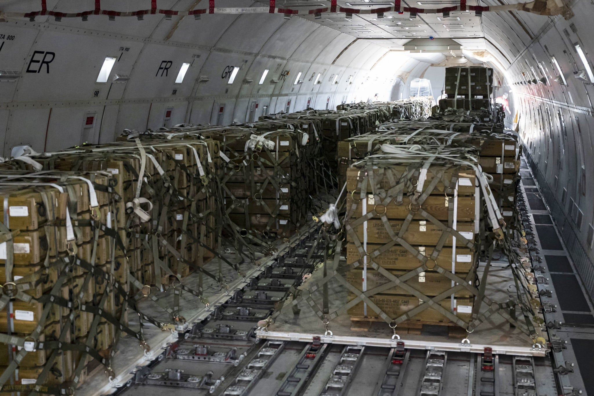 Pallets of ammunition bound for Ukraine are secured onto a commercial plane during a security assistance mission at Dover Air Force Base, Del., July 21, 2022 (Air Force Senior Airman Faith Schaefer/Department of Defense)