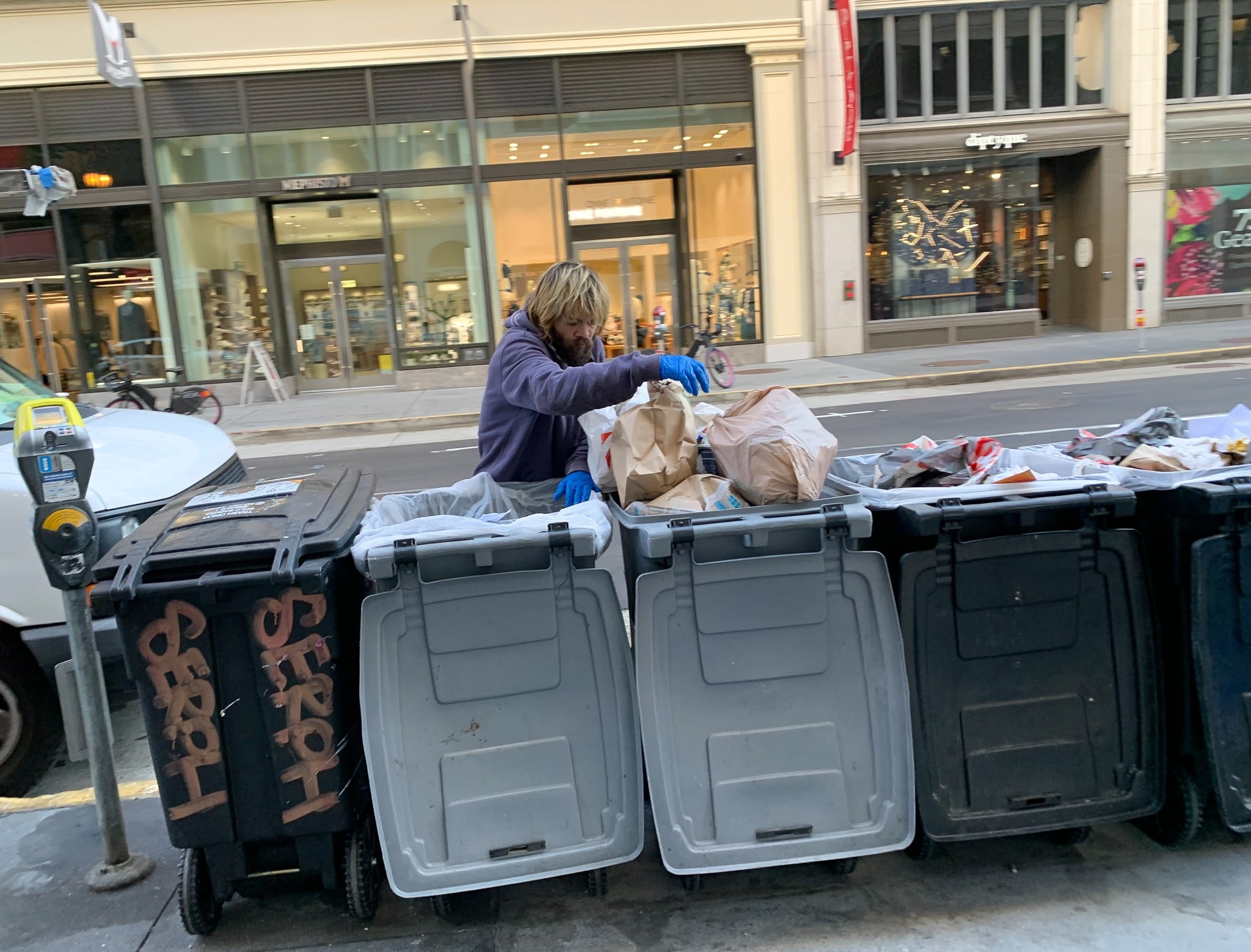 A homeless man searches through garbage in San Francisco, California (The American Spectator)