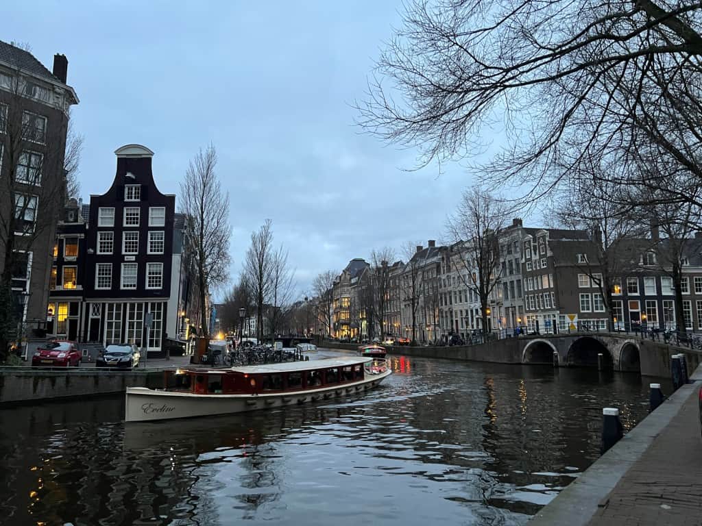 A small vessel navigates Amsterdam’s Herrengracht (image credit: Jeremy Hildreth)
