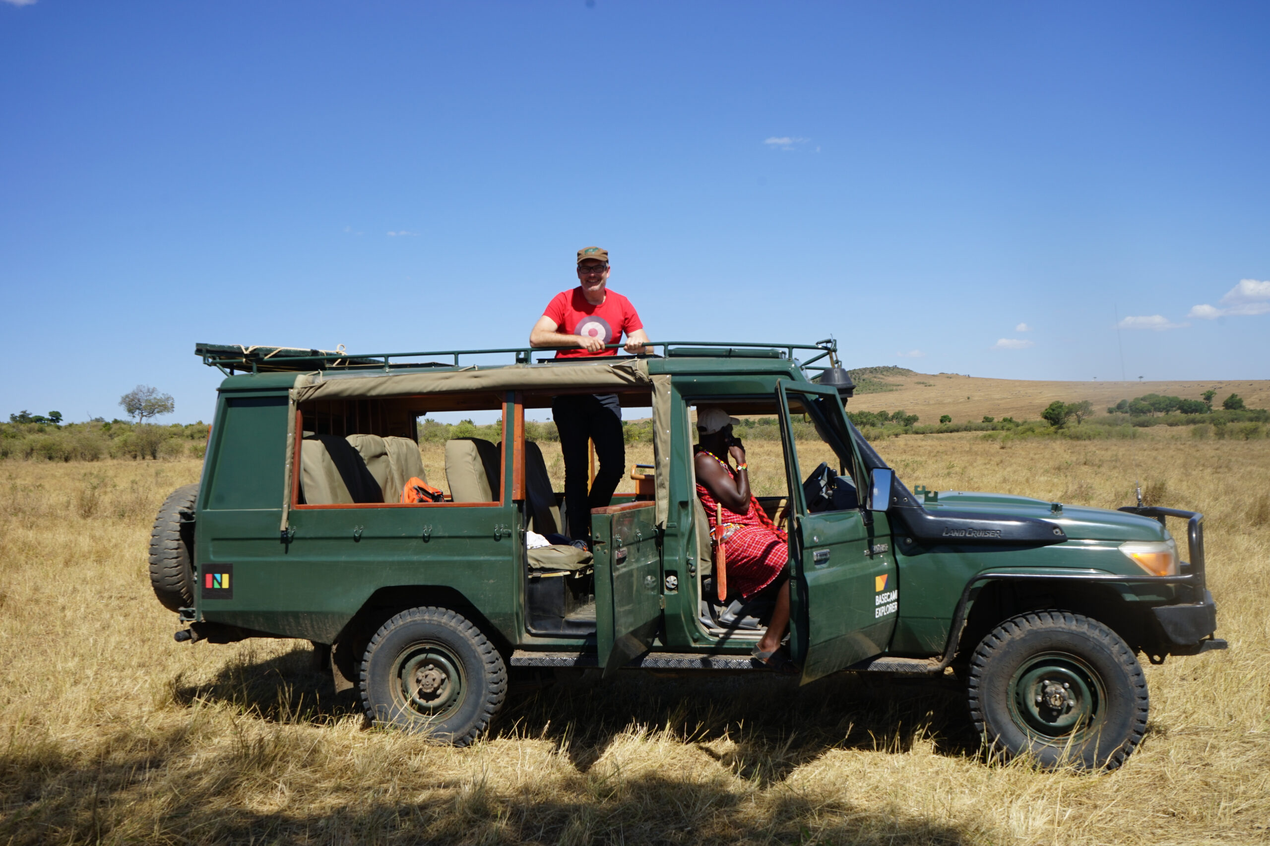 People on safari vehicle in savanna