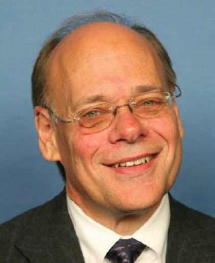 Smiling older man wearing glasses and suit